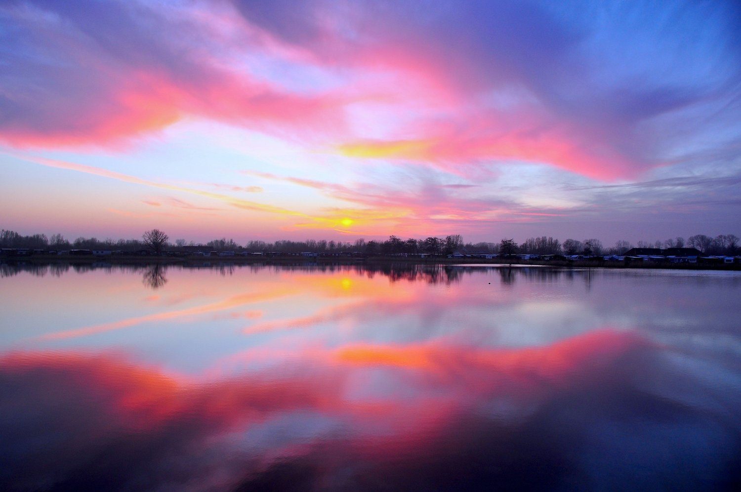 Violet and rose light over still sacred water