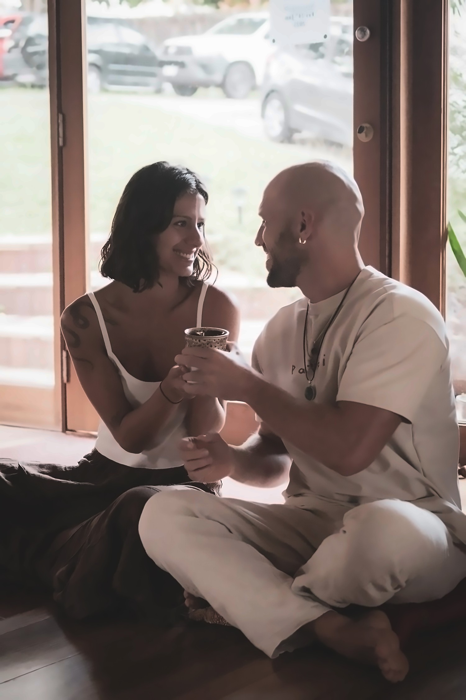 A one-on-one healing session in a warm, candle-lit room