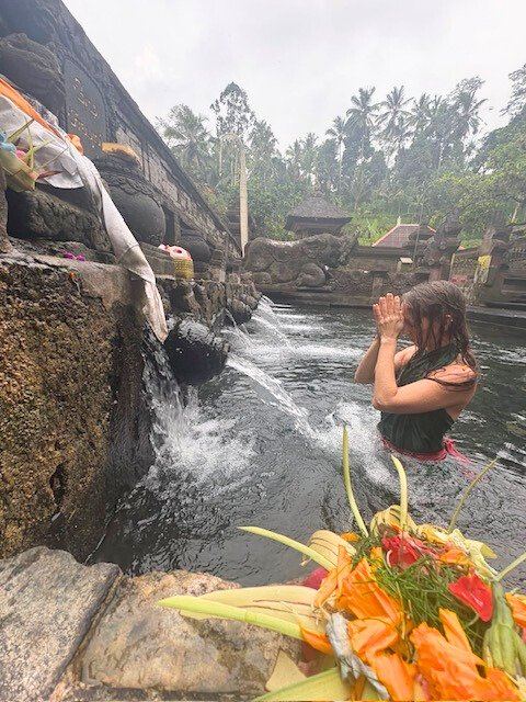 A flower offering at a sacred waterfall
